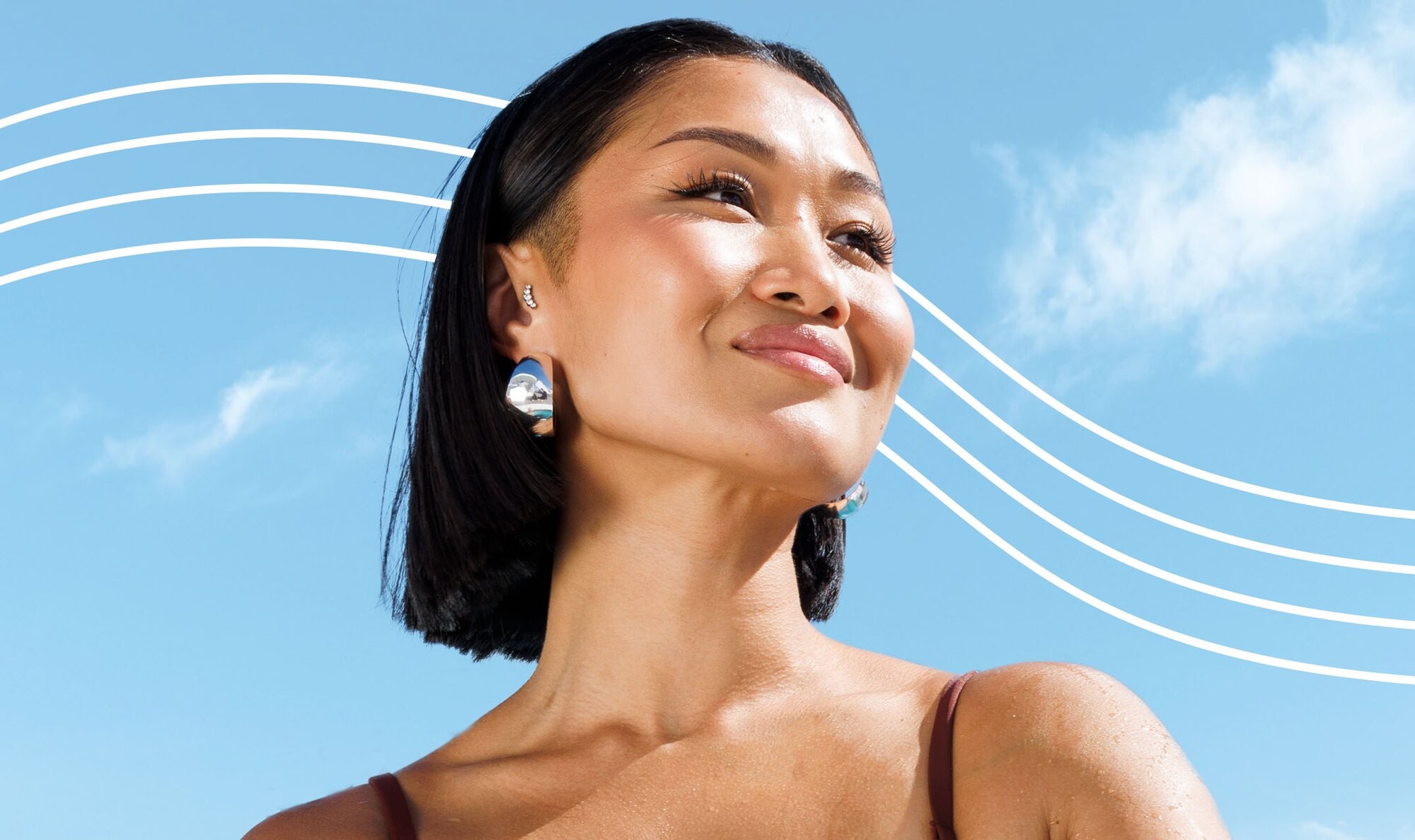 Confident Asian woman who just got eyebrow laser hair removal grinning and looking right
